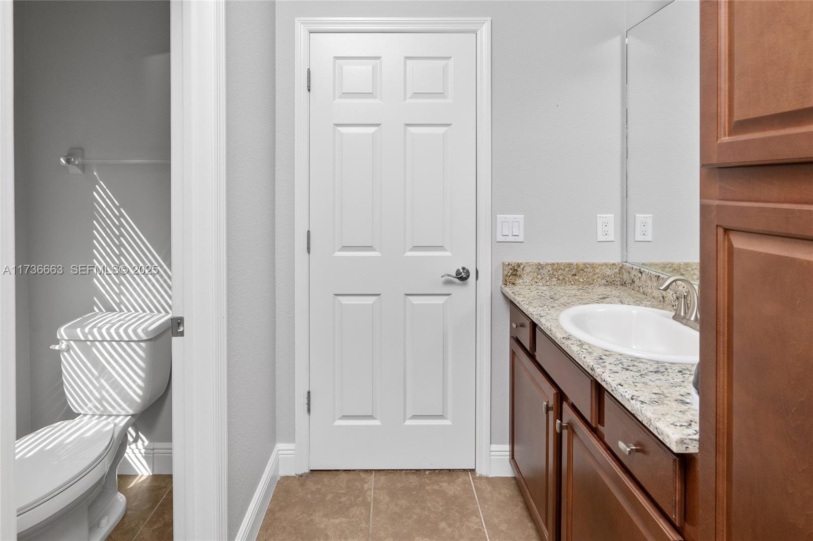 11436 Drifting Leaf Drive Riverview, FL 33579 - Photo 16 of 21 a bathroom with a granite countertop sink and a toilet