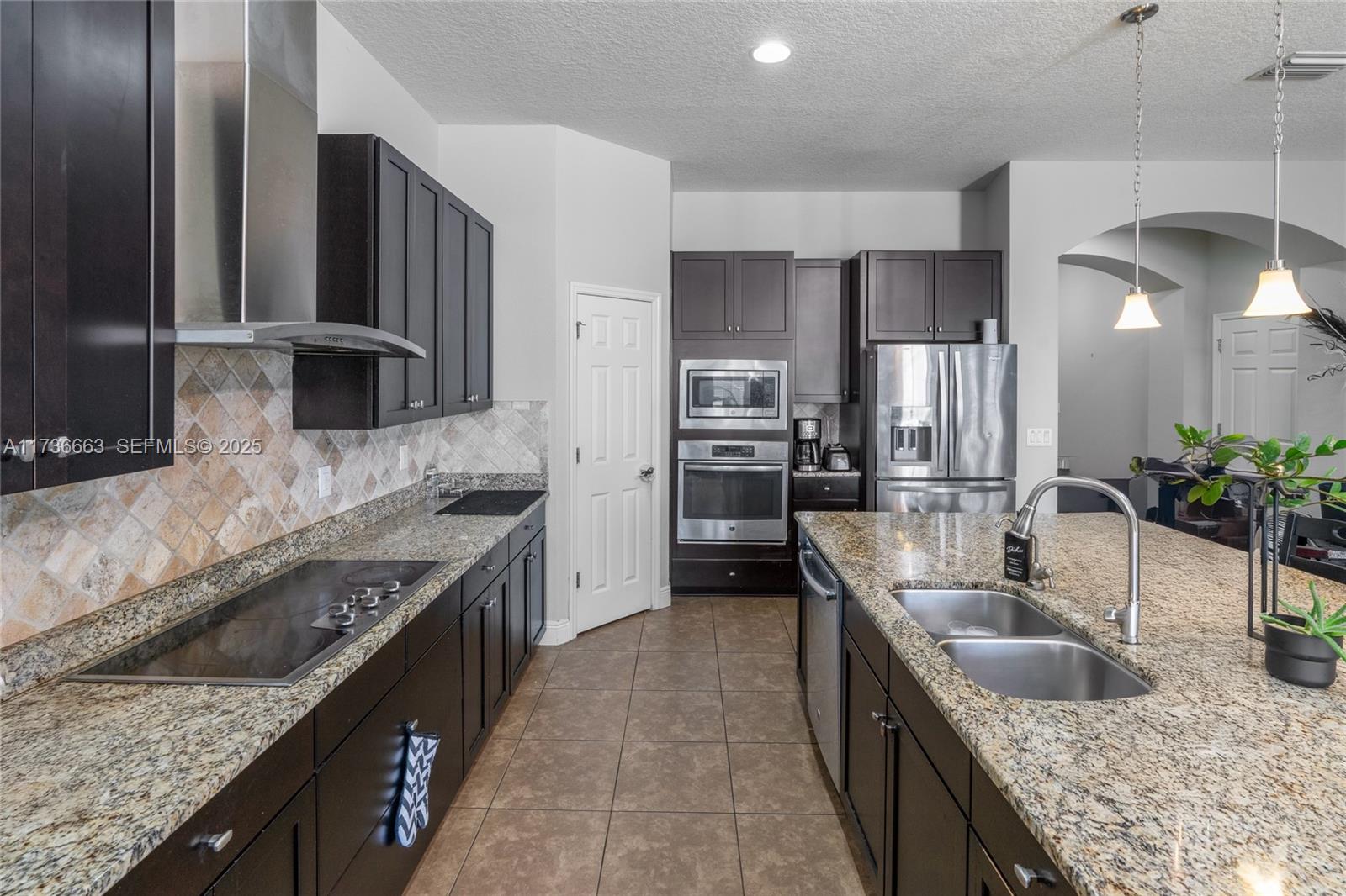 11436 Drifting Leaf Drive Riverview, FL 33579 - Photo 5 of 21 a kitchen with stainless steel appliances granite countertop a sink a stove and a refrigerator