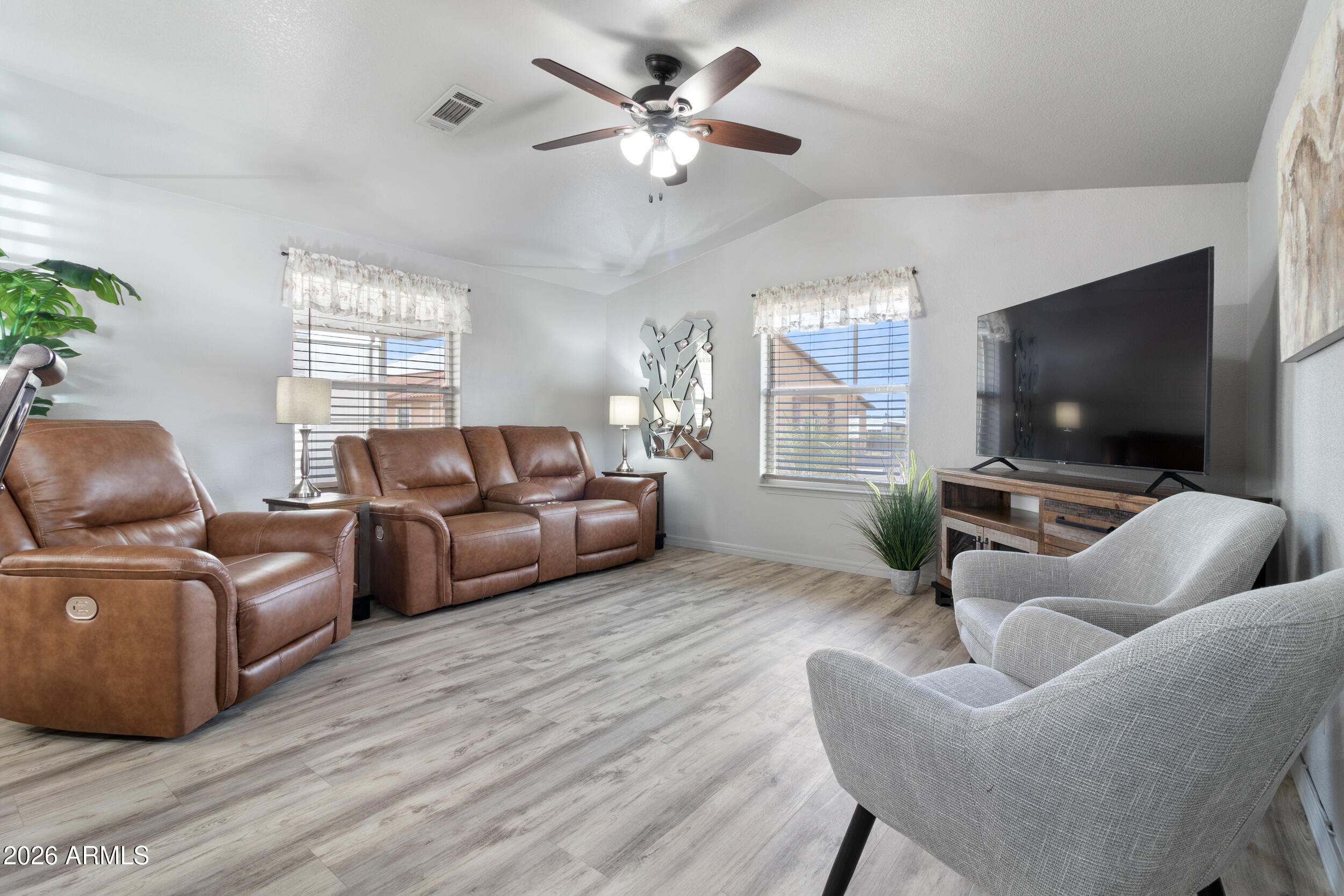 10936 East Apache Trail, Unit 121 Apache Junction, AZ 85120 - Photo 2 of 10 a living room with furniture and a flat screen tv