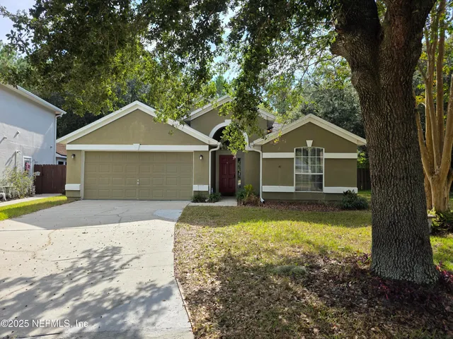 a front view of a house with yard and garage