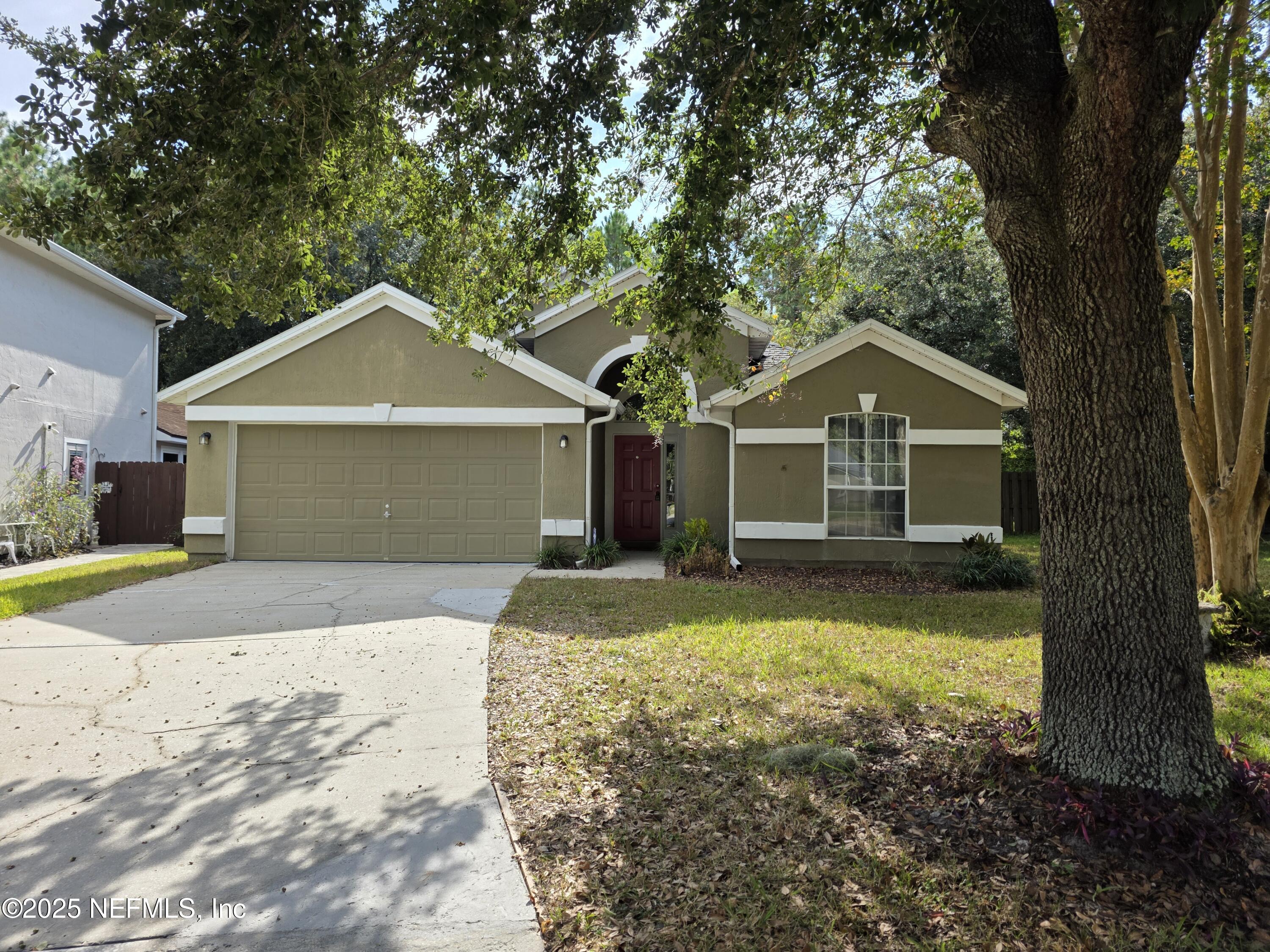a front view of a house with yard and garage