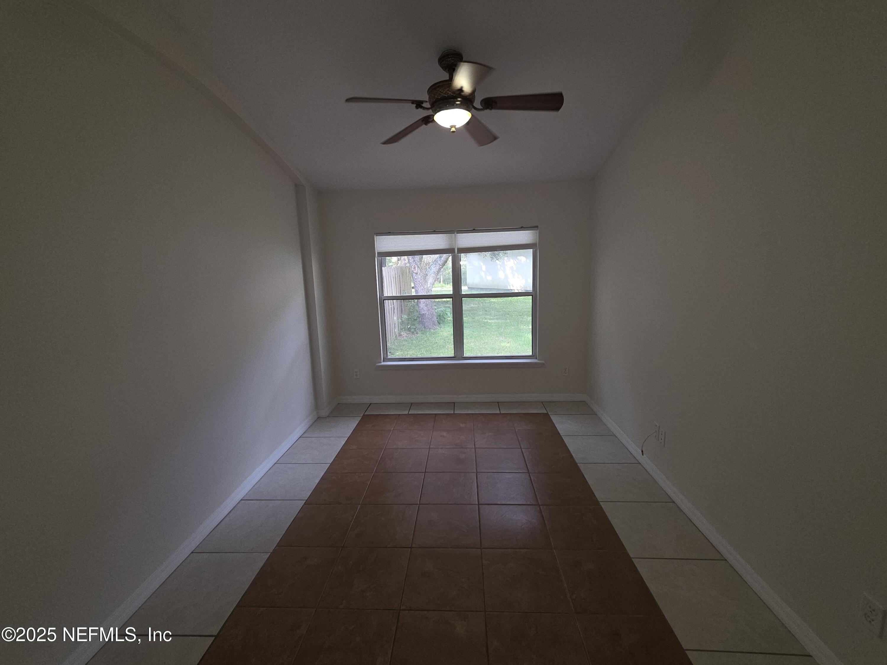 1713 Austin Lane St. Augustine, FL 32092 - Photo 5 of 12 wooden floor in an empty room with a window