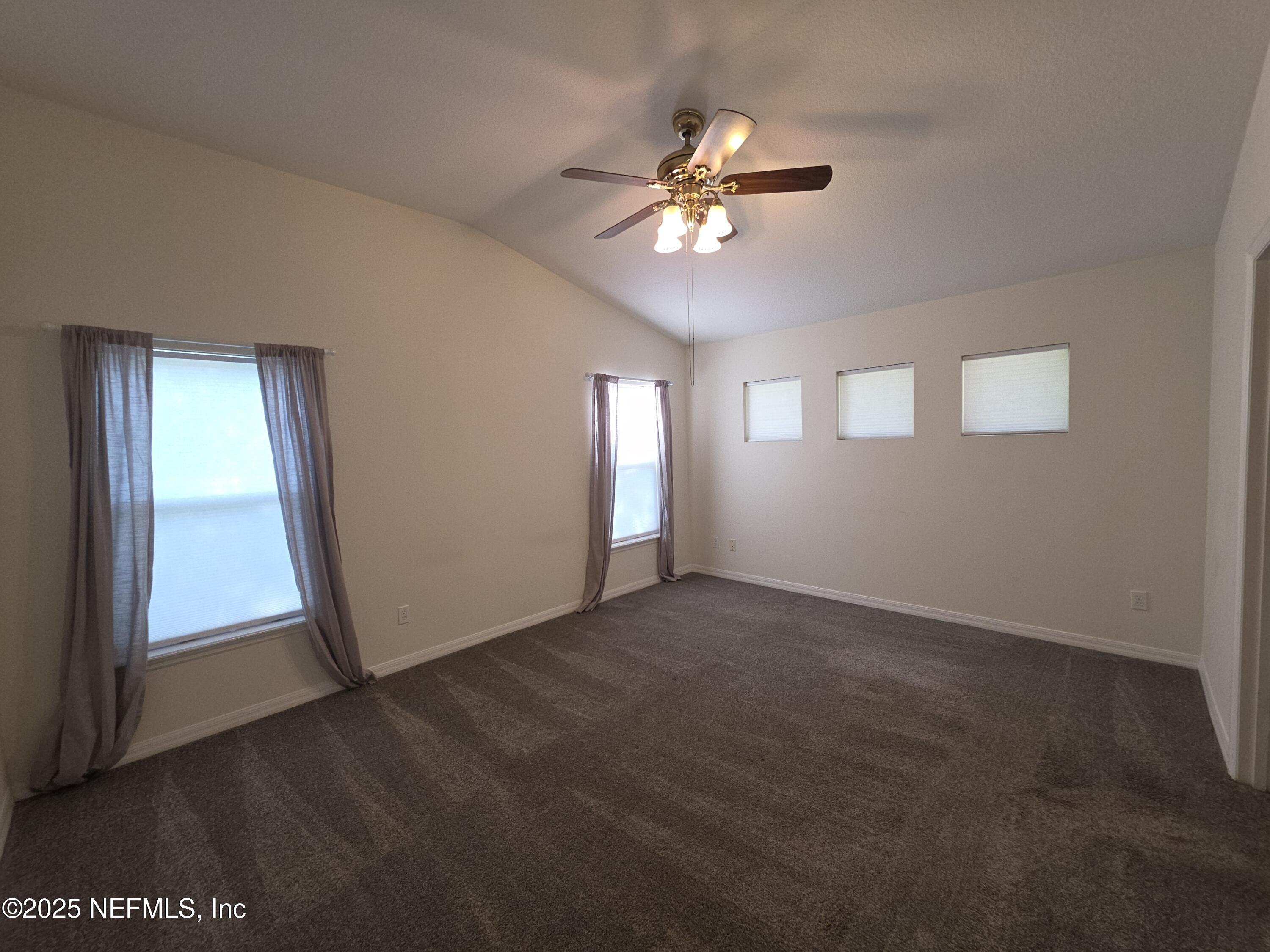 1713 Austin Lane St. Augustine, FL 32092 - Photo 6 of 12 a view of an empty room with window and chandelier fan