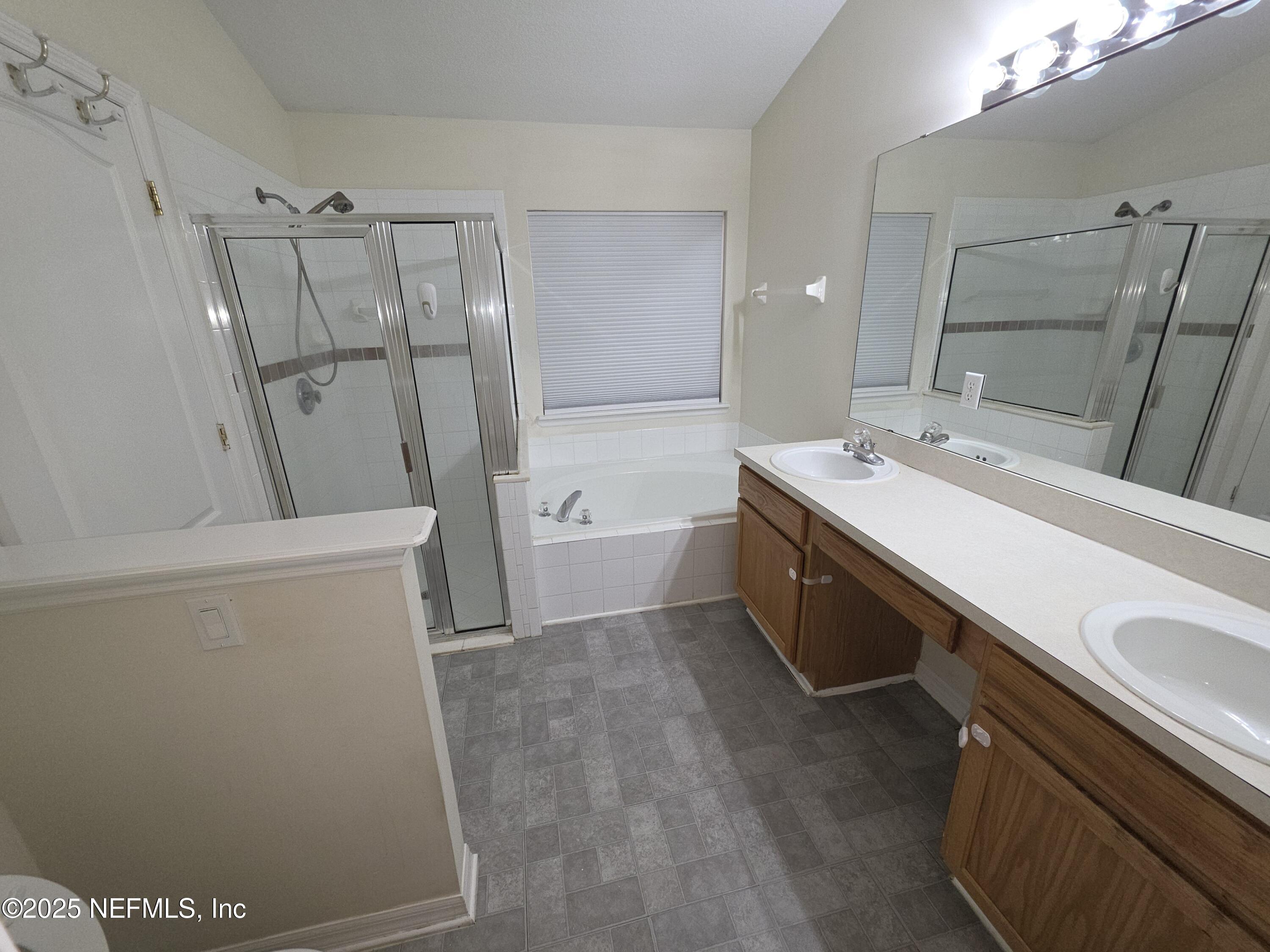 1713 Austin Lane St. Augustine, FL 32092 - Photo 7 of 12 a bathroom with a double vanity sink toilet and tub