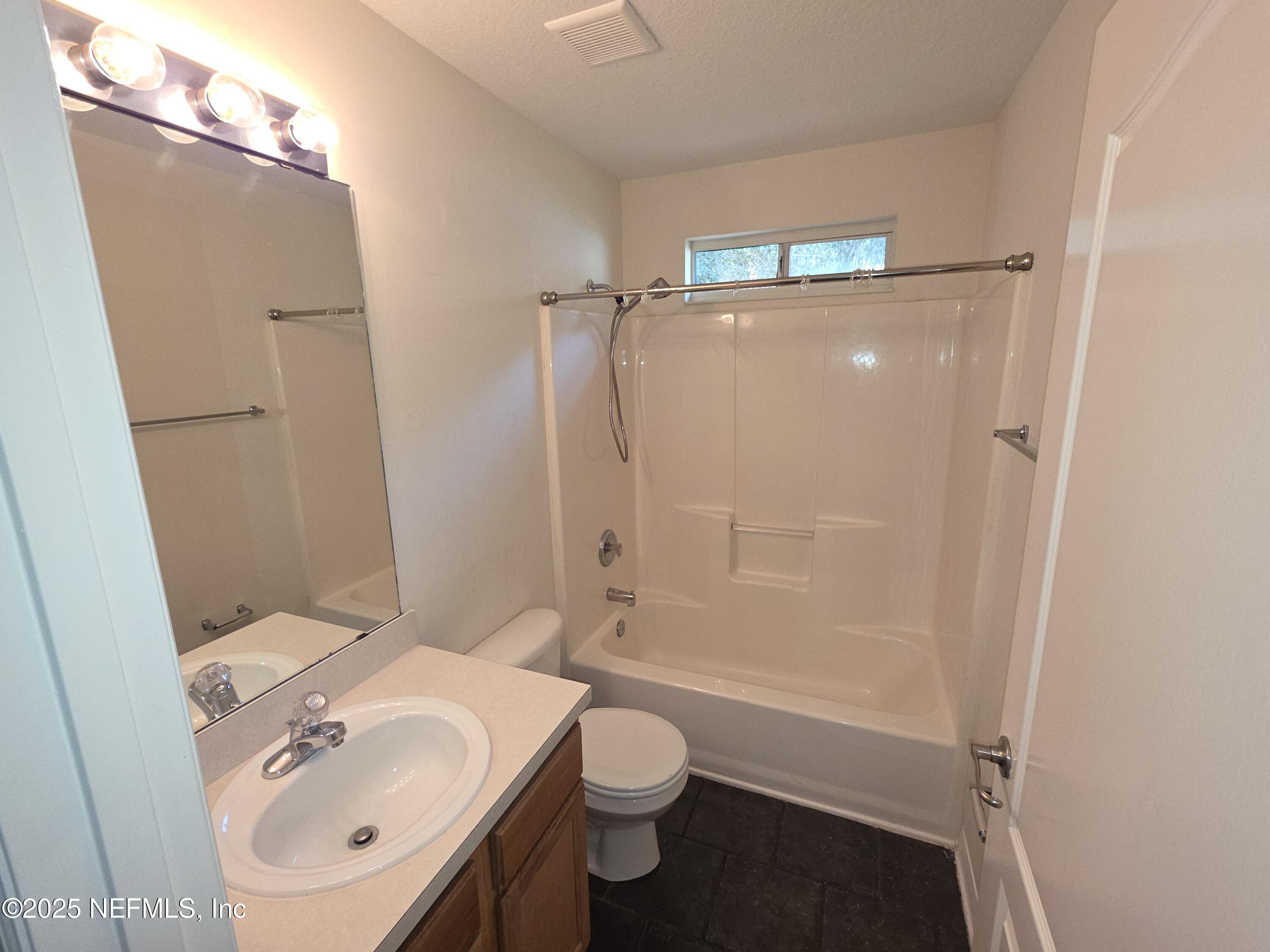 1713 Austin Lane St. Augustine, FL 32092 - Photo 9 of 12 a bathroom with a sink a toilet and shower