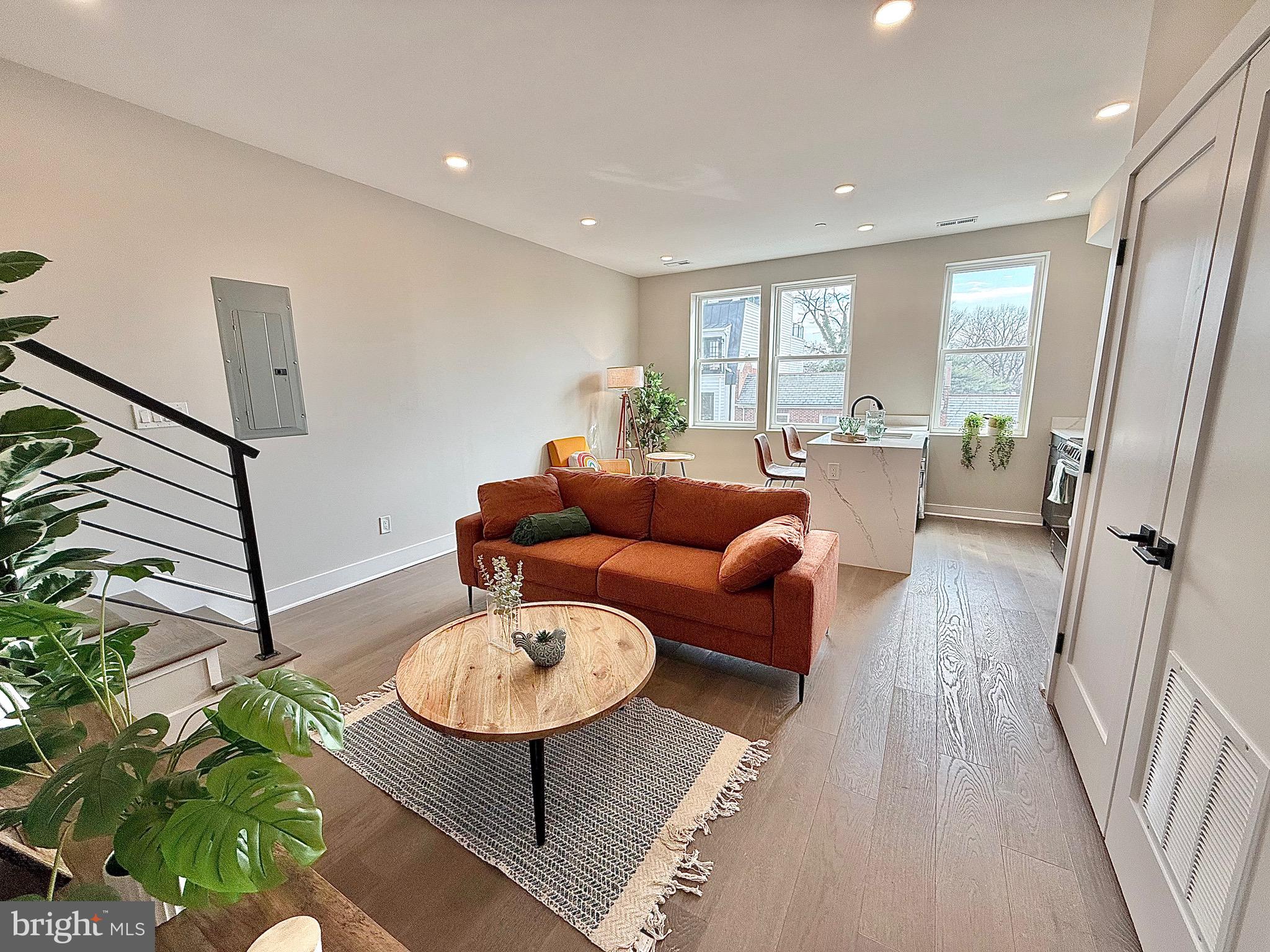 1004 18th Street Northeast, Unit 6 Washington, DC 20002 - Photo 2 of 9 a living room with furniture and wooden floor