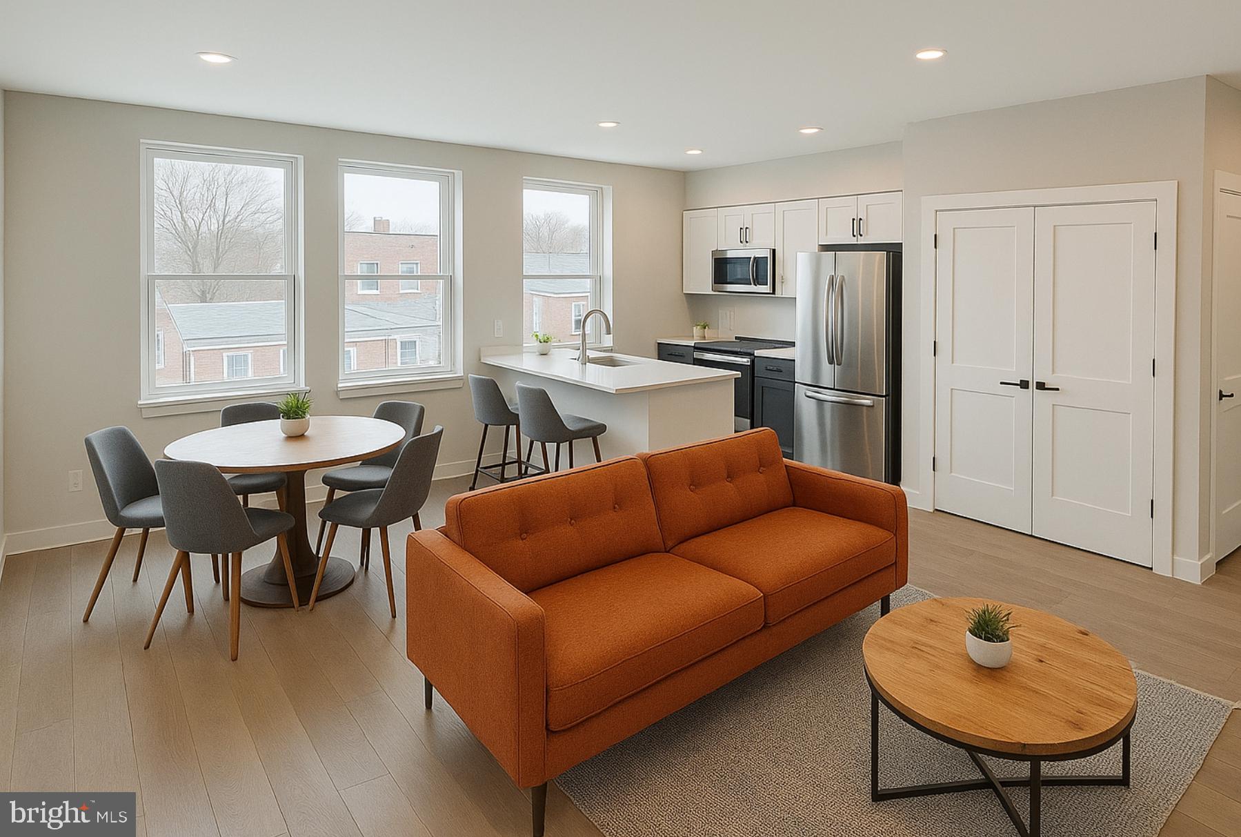 1004 18th Street Northeast, Unit 6 Washington, DC 20002 - Photo 3 of 9 a living room with furniture a refrigerator and a dining table