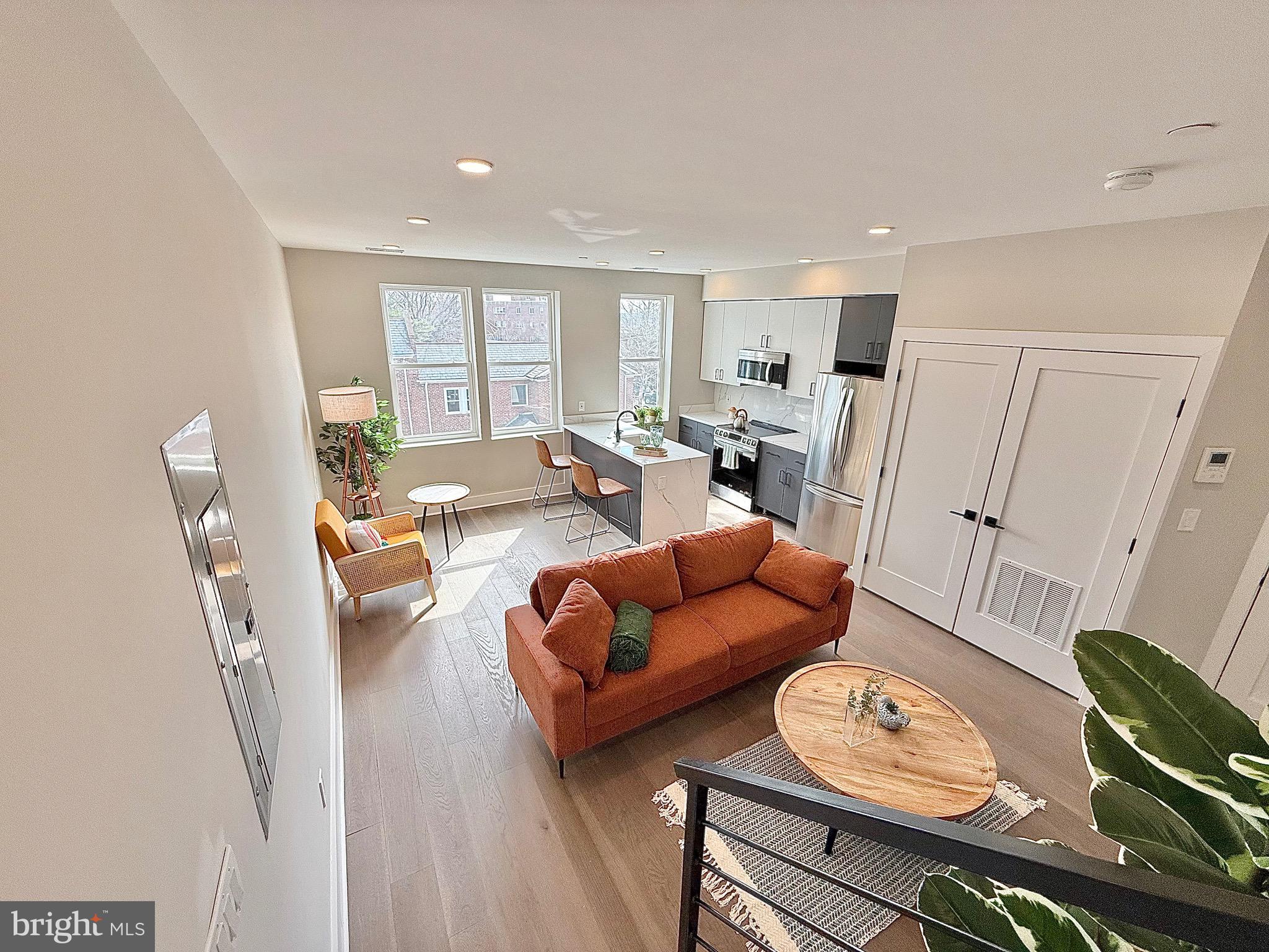 1004 18th Street Northeast, Unit 6 Washington, DC 20002 - Photo 4 of 9 a living room with furniture and wooden floor