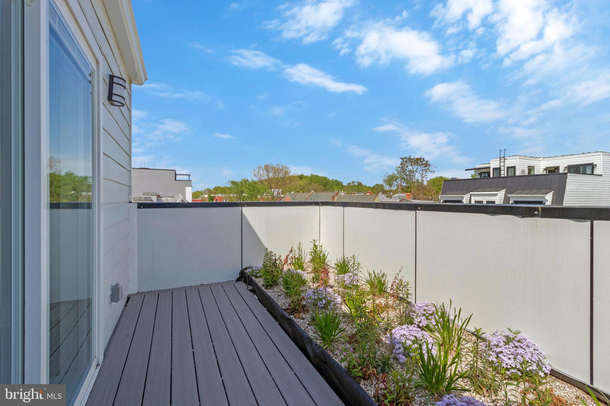 1004 18th Street Northeast, Unit 6 Washington, DC 20002 - Photo 9 of 9 a view of a balcony with wooden floor and plants