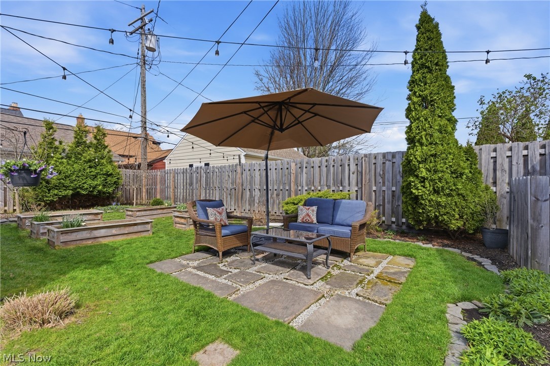 2552 Channing Road Cleveland, OH 44118 - Photo 27 of 33 Lush backyard featuring stone patio and raised garden beds.