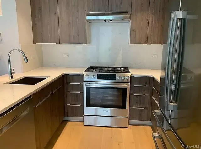 a kitchen with a stove and a refrigerator