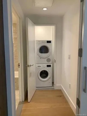 a bathroom with a washing machine and a sink