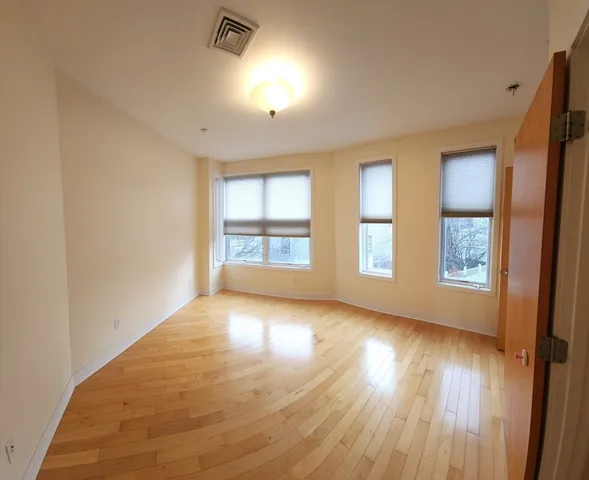 a view of a big room with windows and entryway