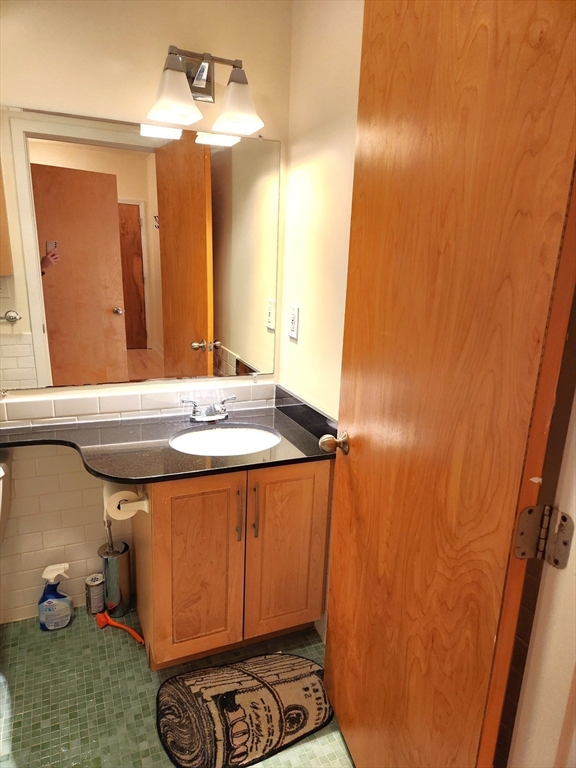 24 Bay State Road, Unit 11 Cambridge, MA 02138 - Photo 19 of 26 a bathroom with a sink and a mirror