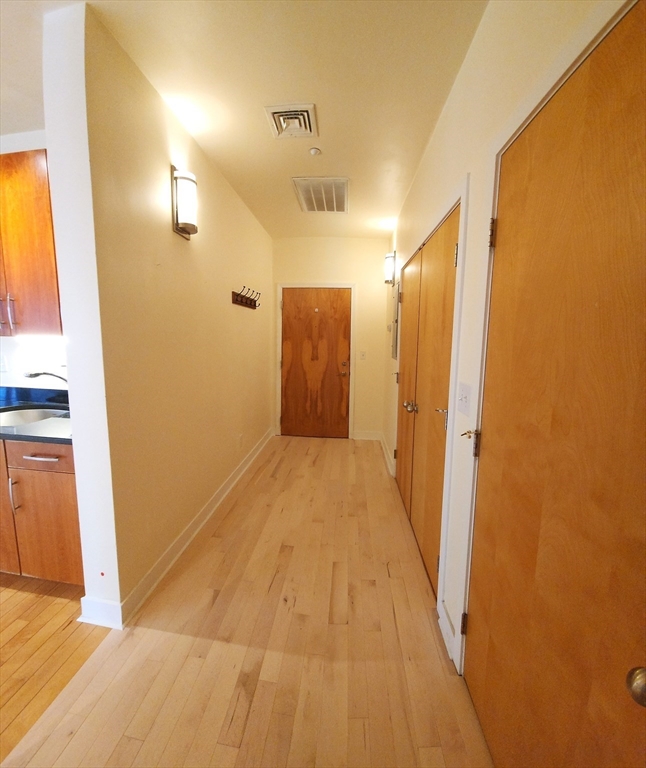24 Bay State Road, Unit 11 Cambridge, MA 02138 - Photo 23 of 26 a view of a bathroom from a hallway
