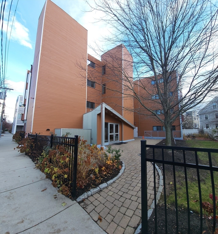 24 Bay State Road, Unit 11 Cambridge, MA 02138 - Photo 4 of 26 a front view of a house with a yard