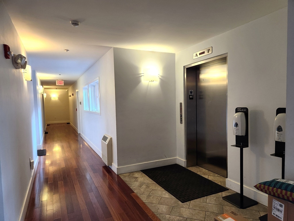 24 Bay State Road, Unit 11 Cambridge, MA 02138 - Photo 6 of 26 a view of a hallway with wooden floor