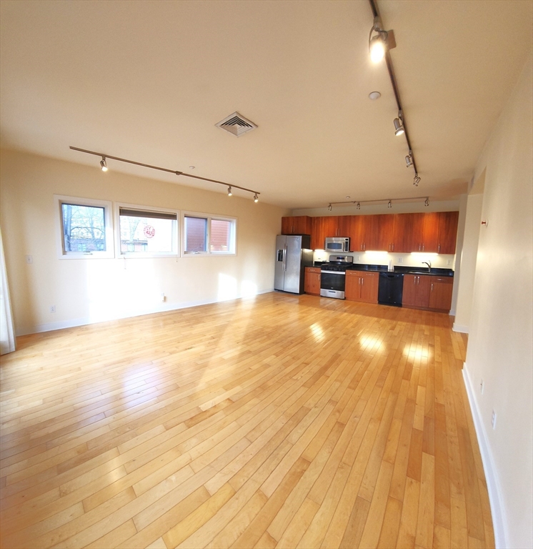 24 Bay State Road, Unit 11 Cambridge, MA 02138 - Photo 7 of 26 a view of empty room with wooden floor