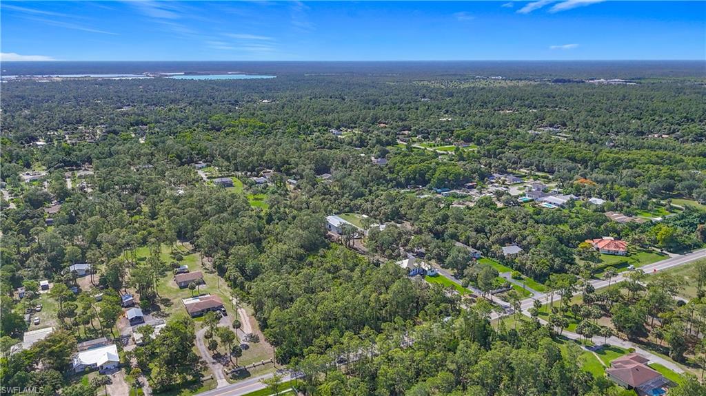 23rd Street Southwest Naples, FL 34117 - Photo 1 of 17 Aerial view of property's location with a heavily wooded area
