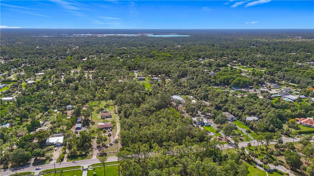 23rd Street Southwest Naples, FL 34117 - Photo 2 of 17 Aerial overview of property's location with a heavily wooded area
