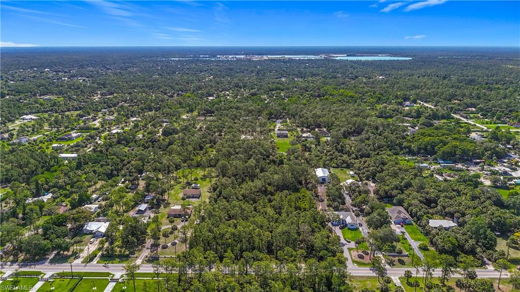 23rd Street Southwest Naples, FL 34117 - Photo 3 of 17 Aerial view of property and surrounding area featuring a forest