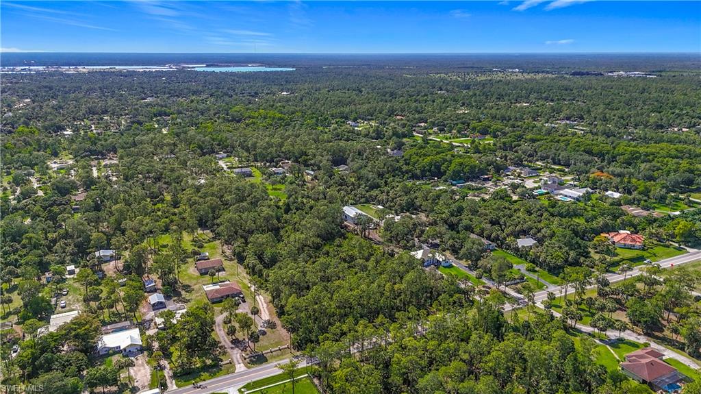 23rd Street Southwest Naples, FL 34117 - Photo 5 of 17 Aerial overview of property's location with a forest