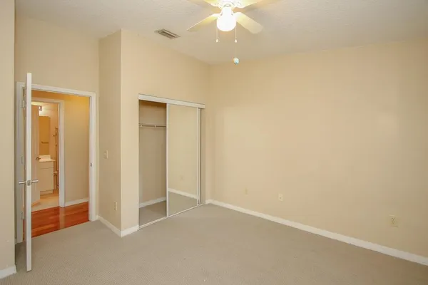 an empty room with windows and fireplace