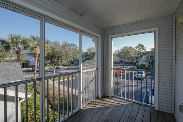 a view of a balcony with wooden floor