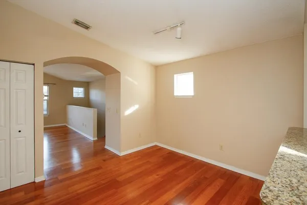 a kitchen with stainless steel appliances granite countertop a refrigerator a stove a sink and a microwave