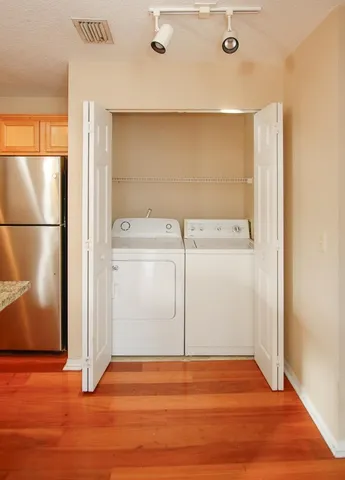 a view of a hallway with wooden floor