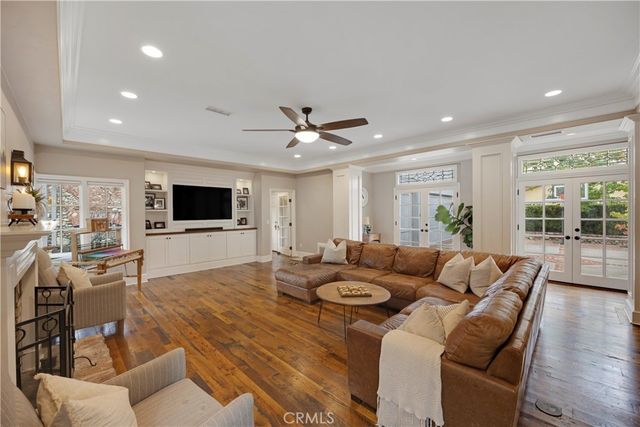 a view of a patio with couches table and chairs and potted plants