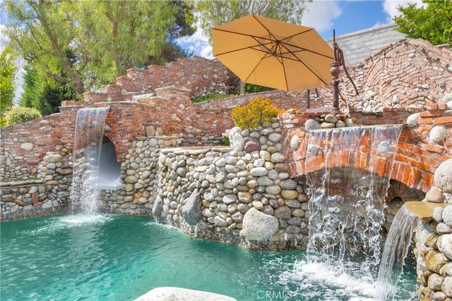 a living room with fireplace furniture and a flat screen tv