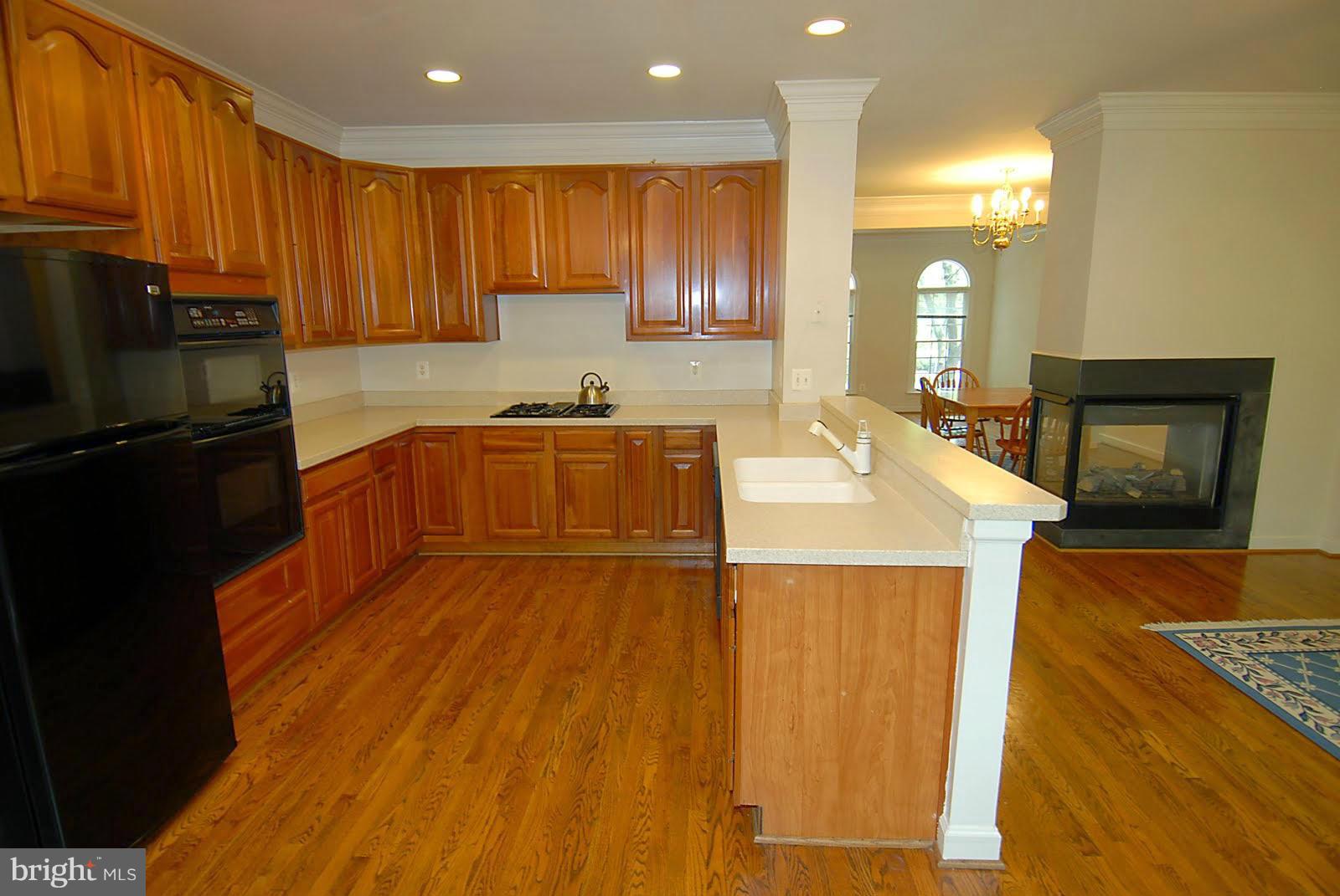 144 Rees Place Falls Church, VA 22046 - Photo 4 of 27 a kitchen with stainless steel appliances granite countertop wooden cabinets a sink dishwasher a stove and a refrigerator
