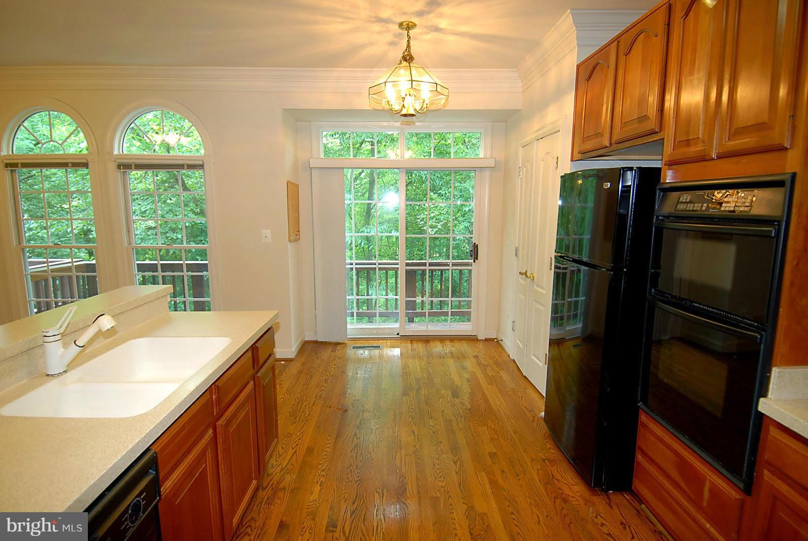 144 Rees Place Falls Church, VA 22046 - Photo 5 of 27 a kitchen with stainless steel appliances granite countertop a refrigerator a stove and a wooden floors