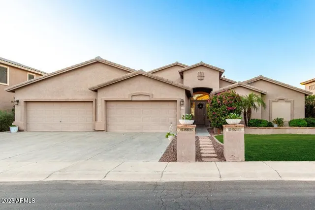a front view of a house with a yard and garage
