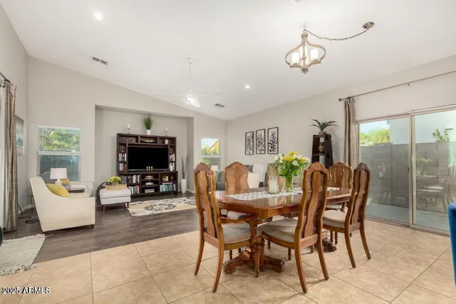 a dining room with furniture a flat screen tv and a large window