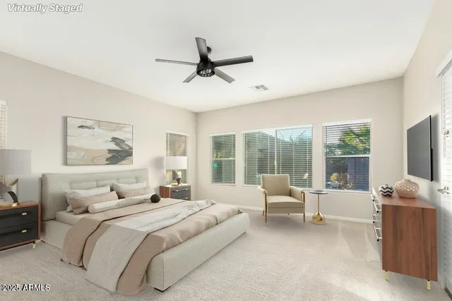 a bedroom with a large bed and a flat screen tv