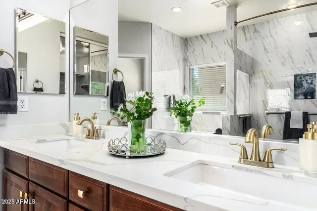a bathroom with sink and mirror