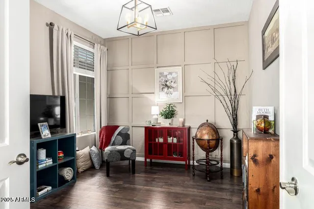 a living room with furniture a flat screen tv and a dining table