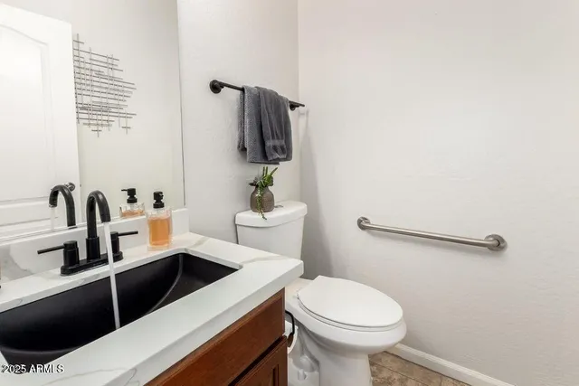 a bathroom with a sink toilet and mirror