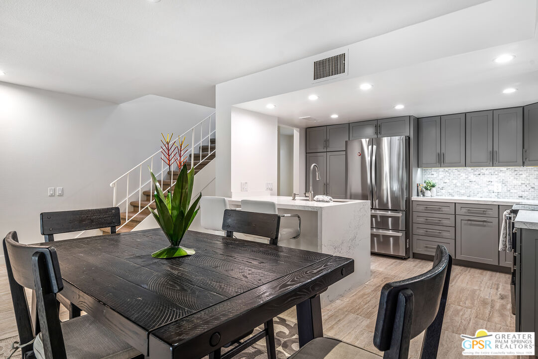 2029 Ramitas Way Palm Springs, CA 92264 - Photo 11 of 41 a kitchen with a table chairs and a refrigerator