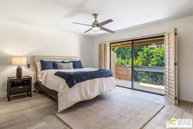 a bedroom with a large bed and a large window