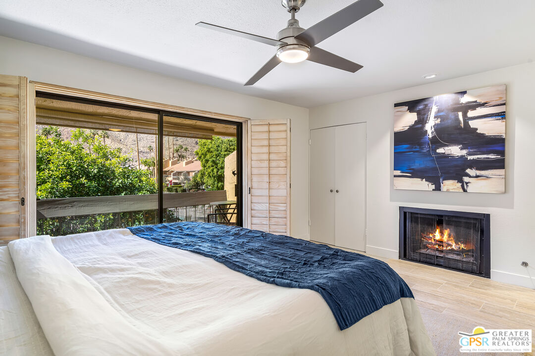 2029 Ramitas Way Palm Springs, CA 92264 - Photo 17 of 41 a bedroom with a bed and a fireplace
