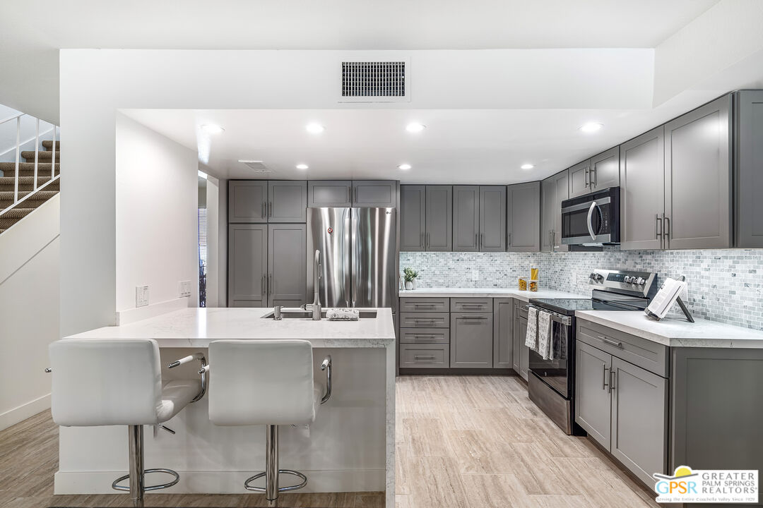 2029 Ramitas Way Palm Springs, CA 92264 - Photo 2 of 41 a kitchen with a sink cabinets and window
