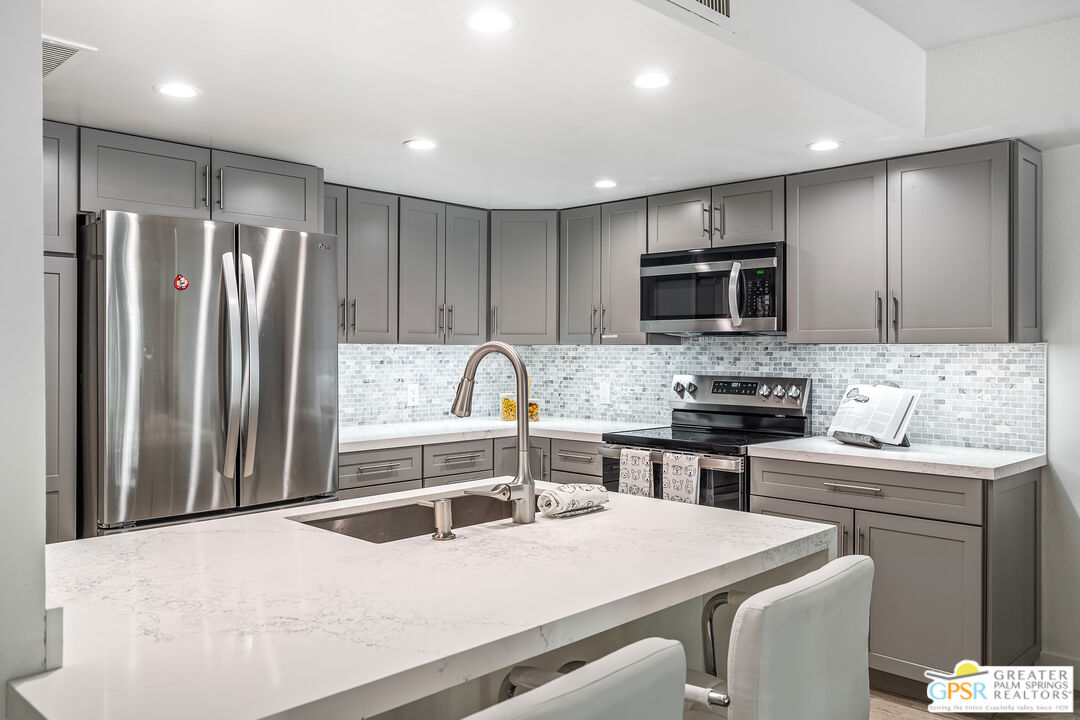 2029 Ramitas Way Palm Springs, CA 92264 - Photo 3 of 41 a kitchen with kitchen island a sink stove and refrigerator