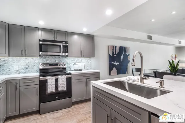 a kitchen with a sink stove and microwave