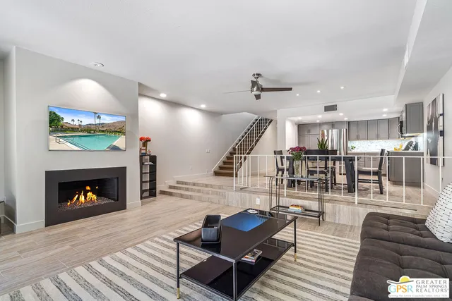 a living room with furniture and a fireplace