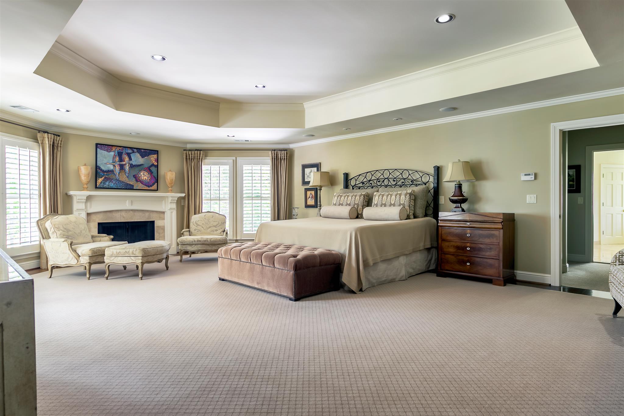 4508 Murfreesboro Road Franklin, TN 37067 - Photo 17 of 30 a spacious bedroom with a bed a fireplace and a large window