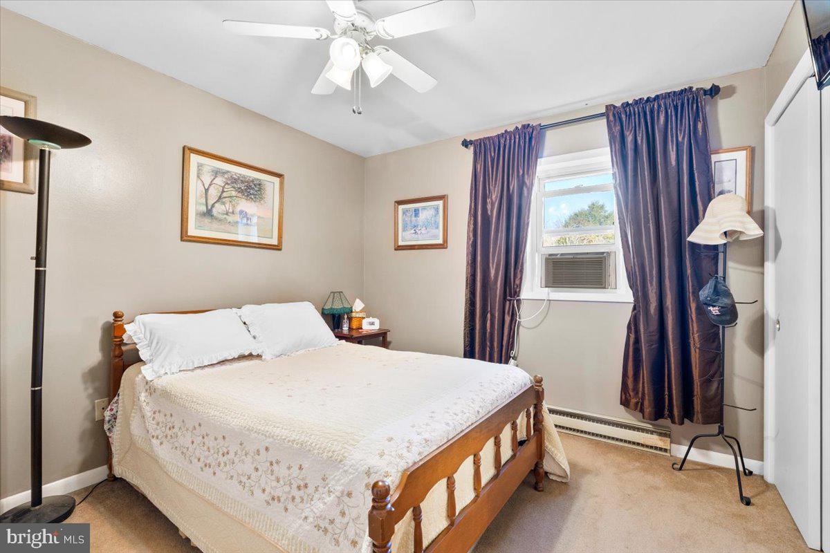 6936 Linganore Road Frederick, MD 21701 - Photo 22 of 33 a bedroom with a bed and a chandelier