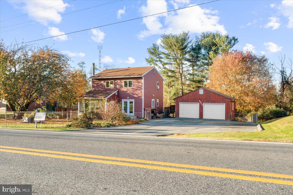 6936 Linganore Road Frederick, MD 21701 - Photo 27 of 33 a view of a house with a swimming pool and a big yard